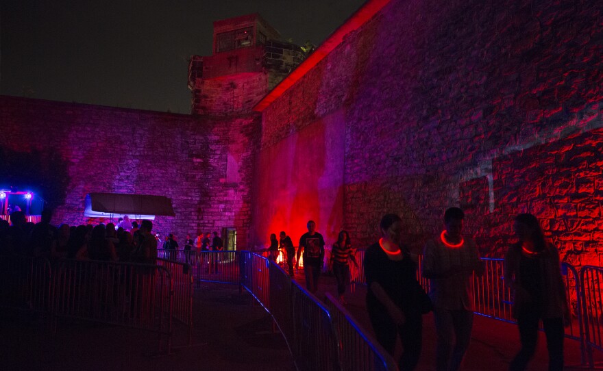 Visitors, some with "high-tech tracking devices," wait to enter the penitentiary. In 2011, the haunted attraction raised 63 percent of the historic site's operating budget.