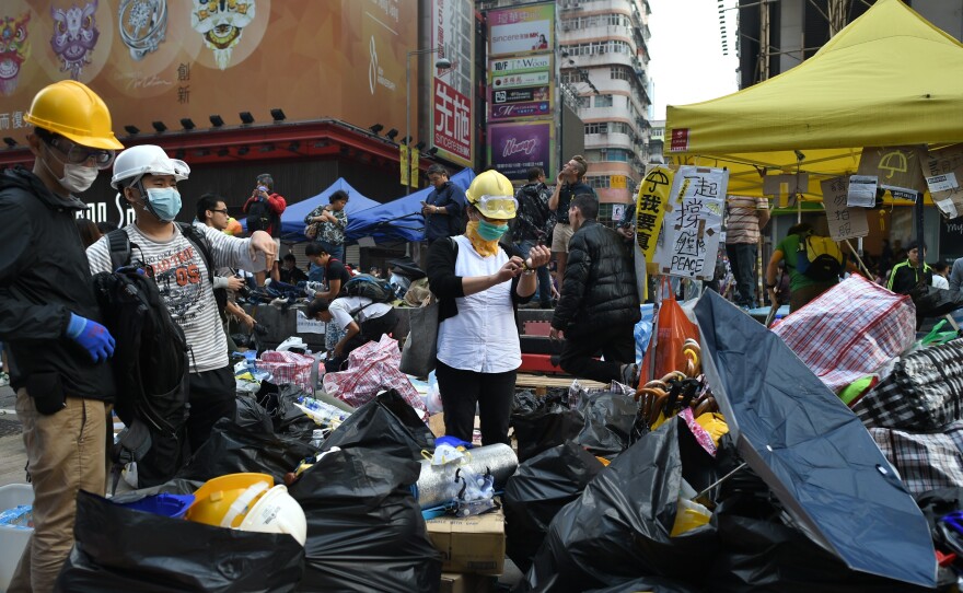 Protesters pack their belongings Wednesday ahead of an expected clearance by bailiffs and police at a pro-democracy protest site in the Mongkok district of Hong Kong.