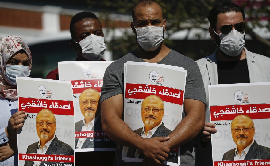People hold posters of slain Saudi journalist Jamal Khashoggi, near the Saudi Arabia consulate in Istanbul, marking the two-year anniversary of his death last October.