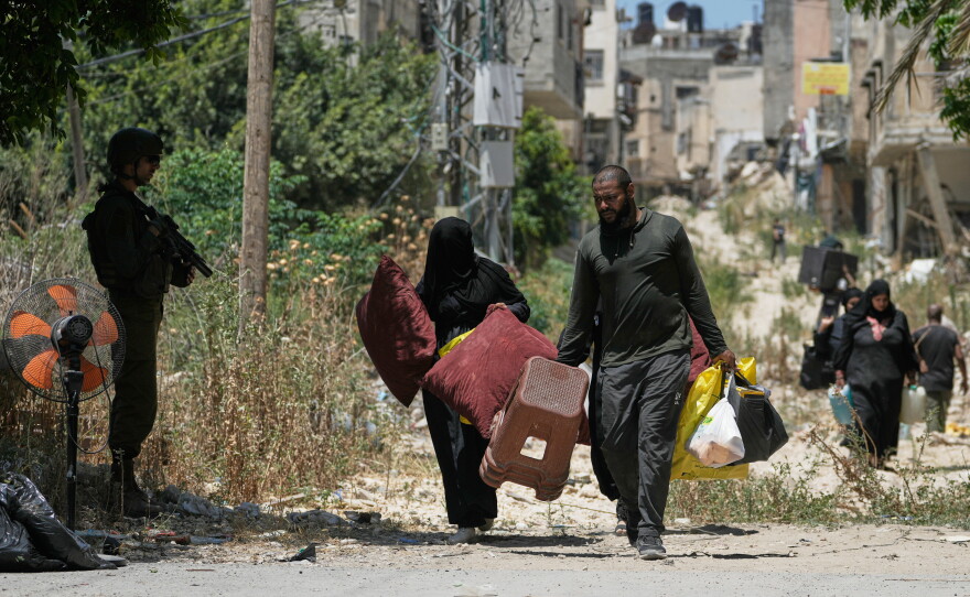 Palestinians collect their belongings from their evacuated homes after the Israeli army issued a number of short term access permits for residents of the occupied West Bank refugee camp of Tulkarem, Wednesday, June 17, 2026.