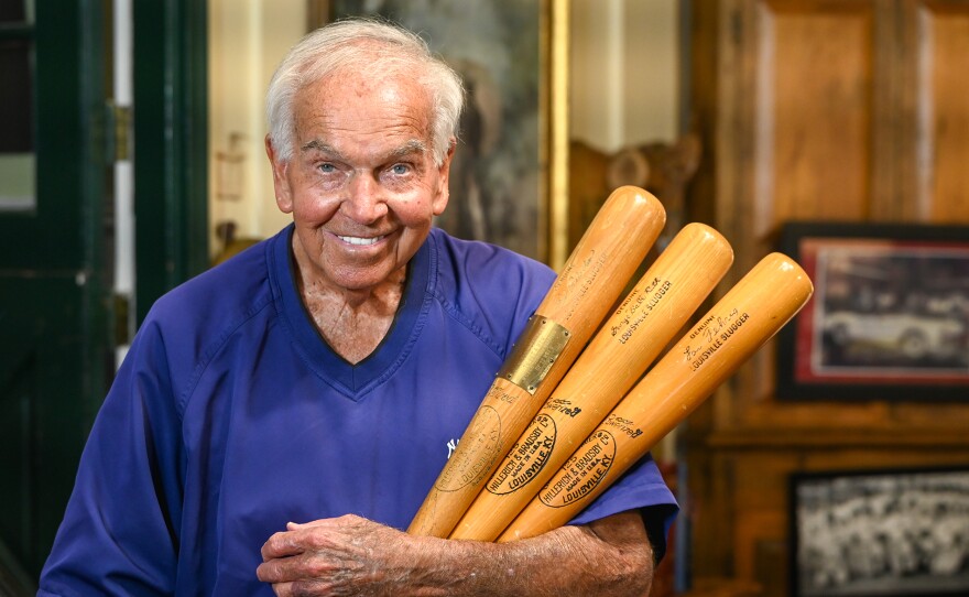 Bobby Richardson poses with three significant bats in New York Yankee history. One is Babe Ruth’s bat, one is Lou Gehrig’s bat, and the third is the very bat Richardson used to hit a grand slam in the 1960 World Series