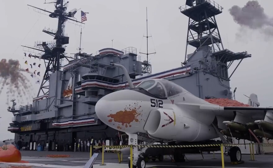 The U.S.S. Midway under attack from flying fruits in "Attack of the Killer Tomatoes: Organic Intelligence." (2026)