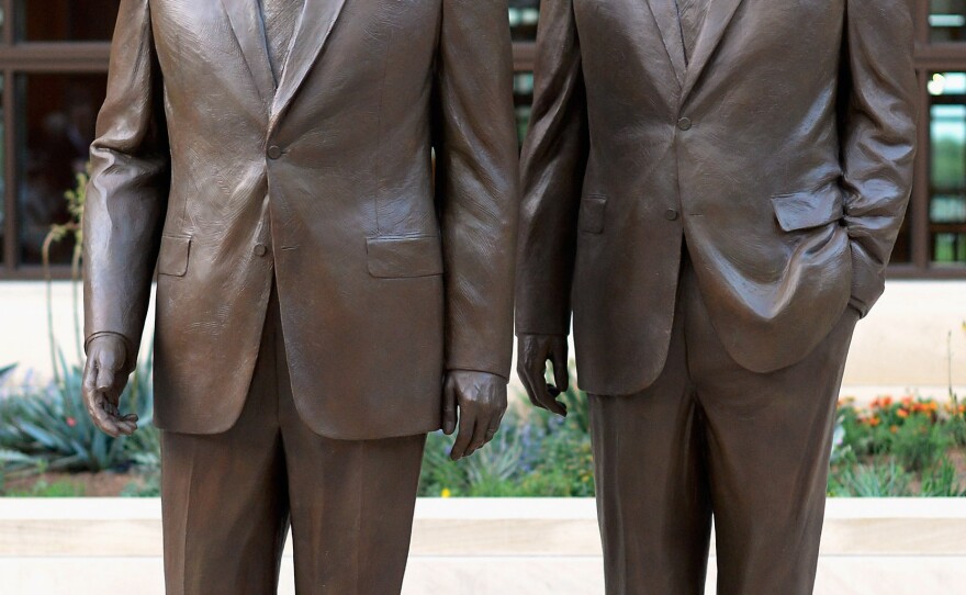 Statues of former Presidents George W. Bush (left) and his father, George H.W. Bush, stand at the George W. Bush Presidential Center on the SMU campus in Dallas, where the George W. Bush Presidential Library and Museum will be dedicated Thursday.