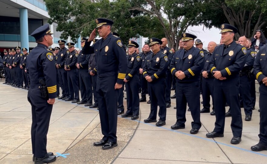Outgoing San Diego Police Chief David Nisleit salutes incoming Chief Scott Wahl at the SDPD Headquarters< June 6, 2024/