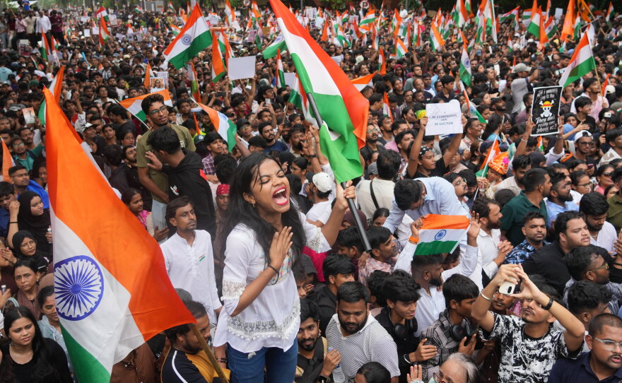 Protesters celebrate after Education Minister Dharmendra Pradhan resigned following nationwide protests as part of the Cockroach Janta Party's protest movement in Mumbai, India, Sunday, July 26, 2026.