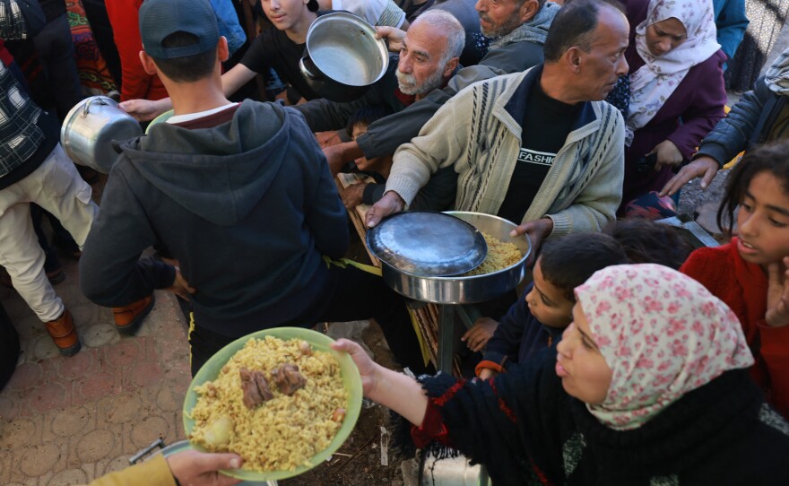 Displaced Palestinians line up for food donations in Rafah on Thursday, the day before the ceasefire expired.
