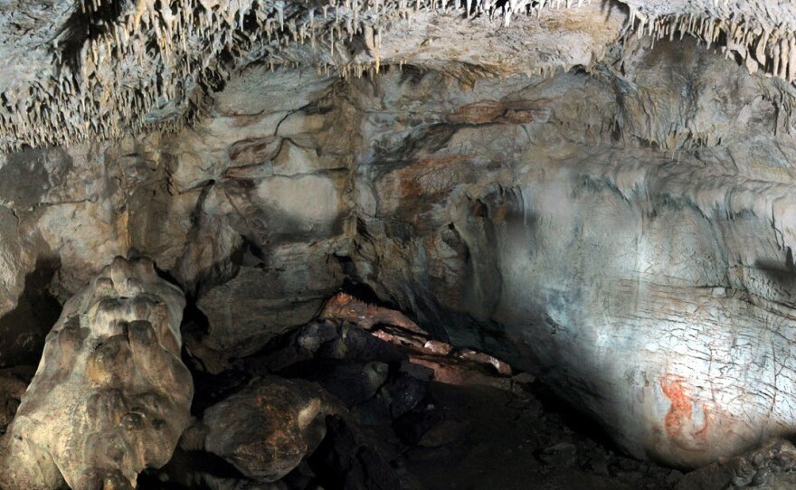 A view inside Grotta Paglicci, in southern Italy, with wall paintings. Scientists say a 32,000-year-old stone found inside the cave was used to grind flour.