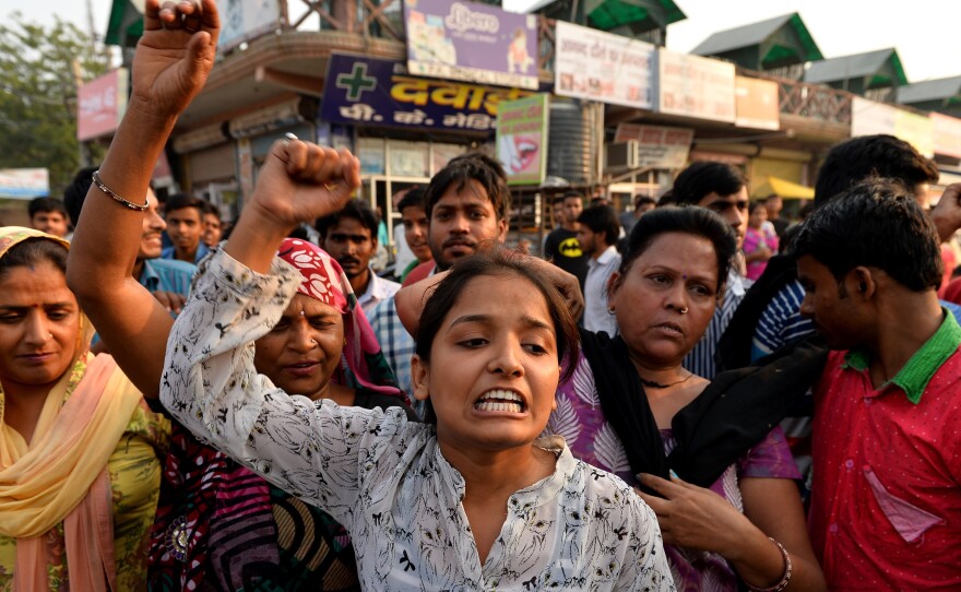 Protesters rally near the home of a girl who was raped in New Delhi on Oct. 17. The Indian government is trying to improve its emergency response system, particularly in cases of assault.