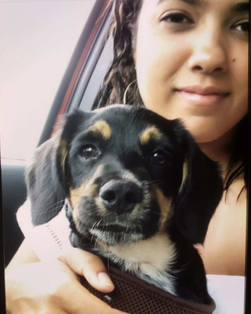 Devon Rideout sits in a car holding her puppy "Chip" in an undated selfie.