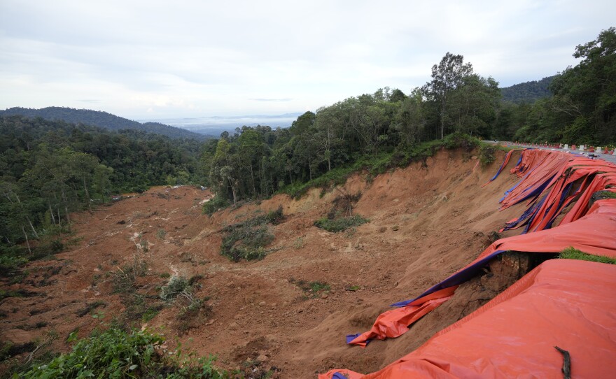 A large swath of soil is seen after Friday's landslide that covered a campground in Batang Kali, Malaysia.