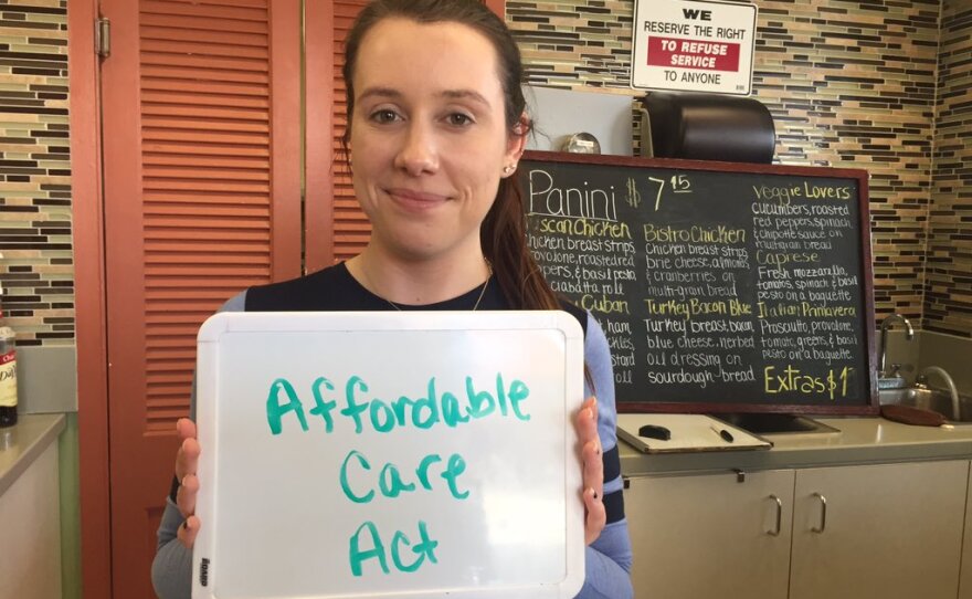 Hannah Fletcher of Santee holds up a sign showing the most important issue to her in the 2016 election, Jan. 22, 2016.