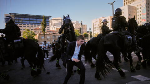 Israeli mounted police disperse Ultra-Orthodox Jews blocking a road during a protest against army draft in Jerusalem, Monday, June 1, 2026.