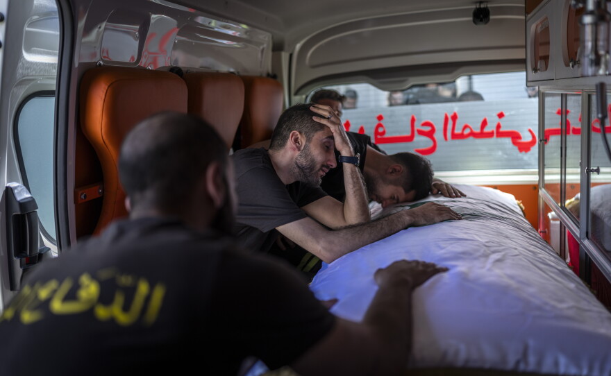 Members of the Civil Defense team mourn the loss of Lebanese Civil Defense members Hussein Jaber and Ahmad Noura, who were killed in an Israeli strike on the southern town of Nabatieh on May 12.