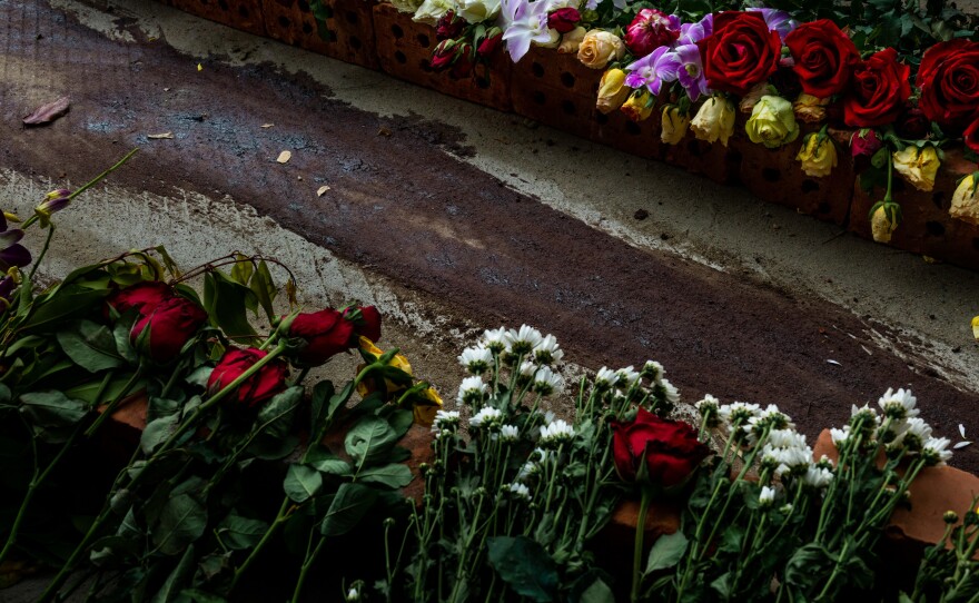 Flowers line the street next to dried blood at the spot where Chit Min Thu, 25, was killed in clashes on March 11 in Yangon, Myanmar. The military junta cracked down brutally on a nationwide civil disobedience movement in which thousands of people have turned out in defiance of tear gas, rubber bullets and live ammunition.