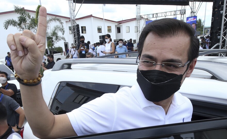 Manila City Mayor Isko Moreno gestures after declaring his bid to run for president in a speech at a public school in the slum area near the place where he grew up in Manila, Philippines on Wednesday Sept. 22, 2021.