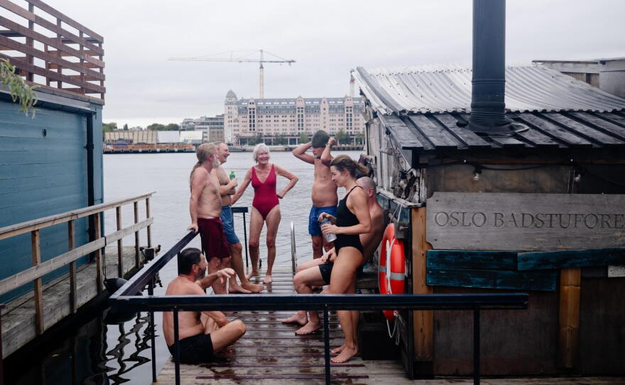 Sauna enthusiasts enjoy an early morning sauna session during the International Sauna Congress 2026 in Oslo, Norway, Sept. 25, 2026. In Oslo Harbor, next to the Opera House and the Munch Museum, lies Sukkerbiten — the Oslo Sauna Association's cluster of many small saunas in a variety of styles, lined up along the pier.