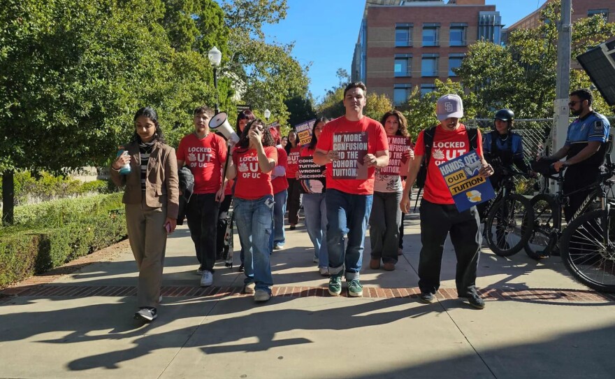 Dozens of UC students march outside a meeting of the University of California Board of Regents in Los Angeles to protest the system’s plan to continue annual tuition increases on Nov. 19, 2025.