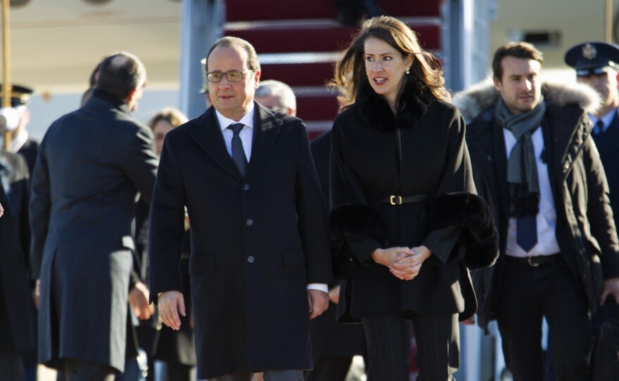 French President François Hollande is accompanied by U.S. Deputy Chief of Protocol Natalie Jones, upon his arrival at Andrews Air Force Base, Md., on Tuesday.