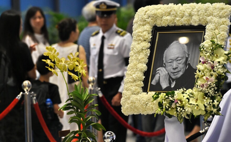 Mourners pay their respects to Singapore's former prime minister Lee Kuan Yew on Friday. Lee, who died last week at age 91, led Singapore's economic transformation.
