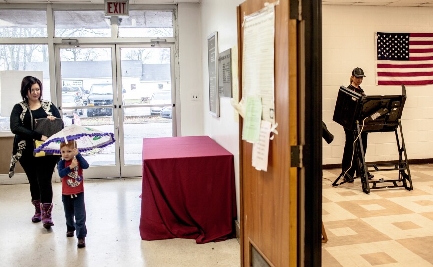 A voter casts her ballot at the polling location inside the county's courthouse building in Marion, Ark. Arkansas had 40 Republican delegates and 32 Democratic delegates at stake in its primaries.