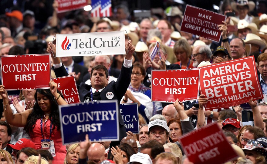 A delegate holds up a sign for Cruz in a sea of Trump supporters on Wednesday night.
