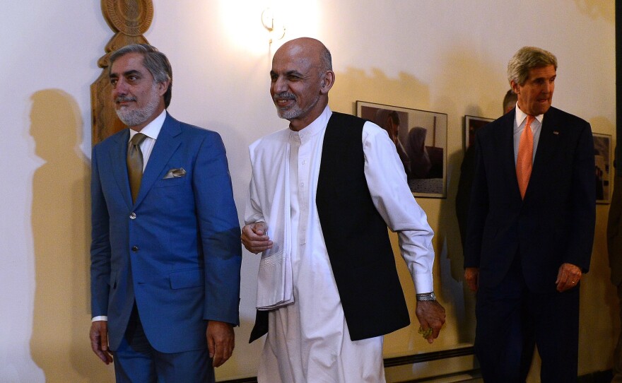Abdullah Abullah (left) and Ashraf Ghani, shown here on August 8, have been contesting the results of Afghanistan's runoff presidential election for months. They are expected to sign a power-sharing deal on Sunday.