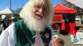 "Sustainable Santa" Richard Nielsen-Eckfield holds a sample given at the Vista Farmers Market, Dec. 17, 2016.