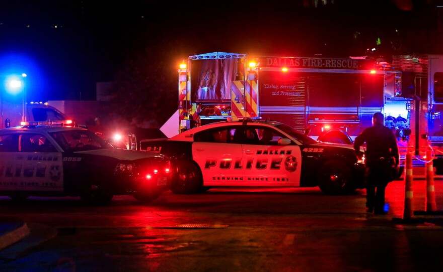 Dallas police work near the scene where Dallas police officers were shot at the end of a protest being held in downtown Dallas in response to recent fatal shootings of two black men by police.