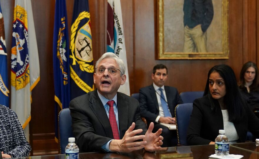 Flanked by US Deputy Attorney General Lisa Monaco (L) and Associate Attorney General Vanita Gupta, Attorney General Merrick Garland convenes a Justice Department component heads meeting at the Justice Department on March 10. Garland was prompted by an NPR story on compassionate release waivers to fix the issue.