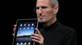 Apple Inc. CEO Steve Jobs holds up the new iPad as he speaks during an Apple Special Event at Yerba Buena Center for the Arts January 27, 2010 in San Francisco, California. Apple introduced its latest creation, the iPad, a mobile tablet browsing device that is a cross between the iPhone and a MacBook laptop.