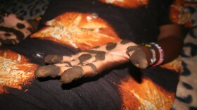 A City Heights Muslim woman prepares to create a henna design on the hands of a close family member on July 28, 2014. In preparation for Eid al-Fitr, women clean and decorate their homes with vibrant colors and adorn their hands and feet with henna designs. 