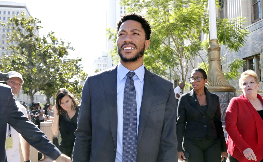NBA star Derrick Rose leaves federal court in Los Angeles. Jurors cleared Rose and two friends in a lawsuit that accused them of gang raping his ex-girlfriend when she was incapacitated.