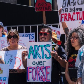 Protesters opposed to San Diego Mayor Todd Gloria's budget cuts to arts programs gather at San Diego's Civic Center Plaza before a City Council meeting on April 20, 2026.