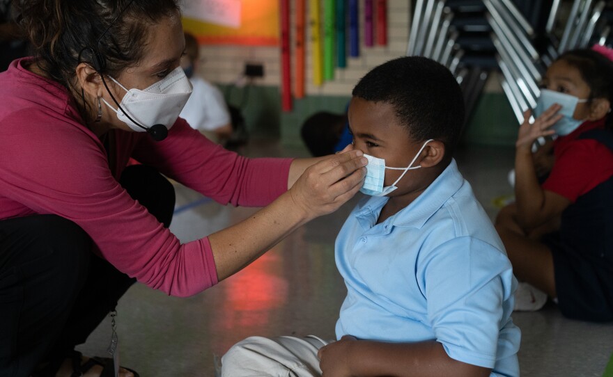 When a student has trouble with his mask, Quesada gets him a new one and helps him put it on properly. She also uses a headset and speaker so students can hear her better through her mask.