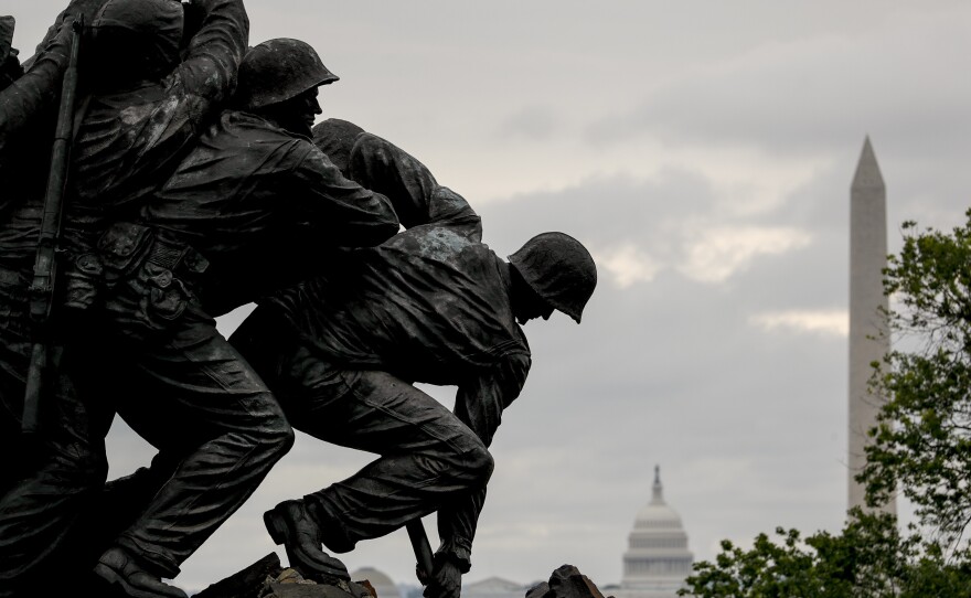 The Washington Monument and the dome of the U.S. Capitol Building are visible behind the U.S. Marine Corps War Memorial in Arlington, Va., on Memorial Day.