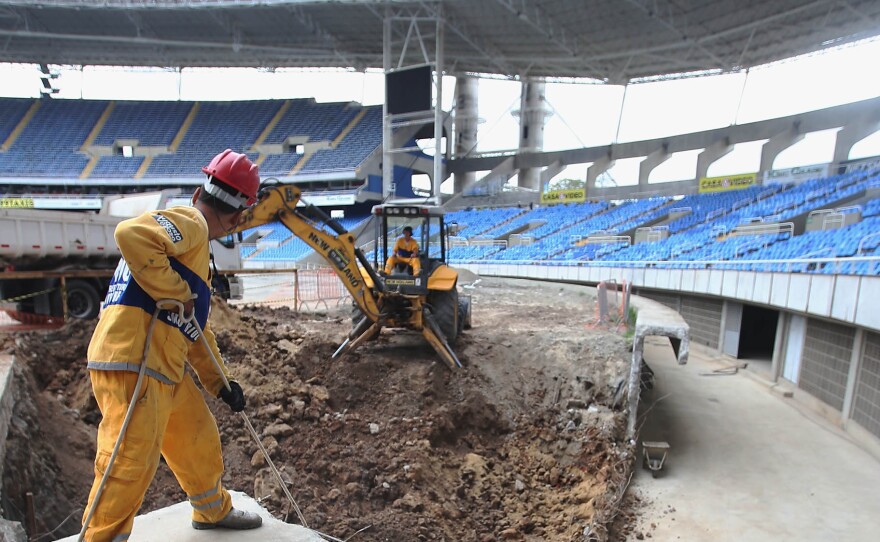 Construction workers building the Olympic Stadium in October 2015. While most venues are ready, or close to ready, costs have been higher than planned and the country is suffering from a recession. Organizers say they are looking for ways to cut costs.