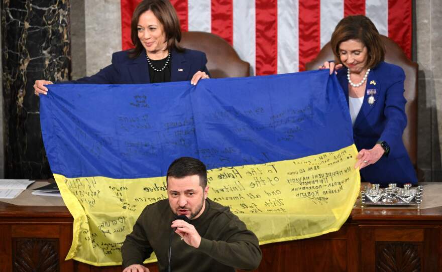 Ukrainian President Volodymyr Zelenskyy speaks to Congress after giving a Ukrainian flag to Vice President Harris and then-Speaker Nancy Pelosi on Dec. 21, 2022.