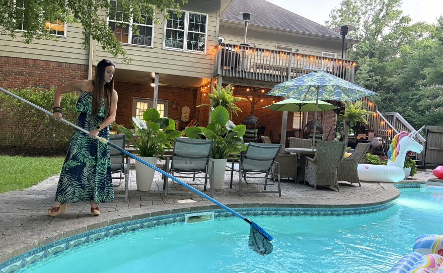 Jasmine Lawson skims her pool in Birmingham, Ala. on June 24, 2026.