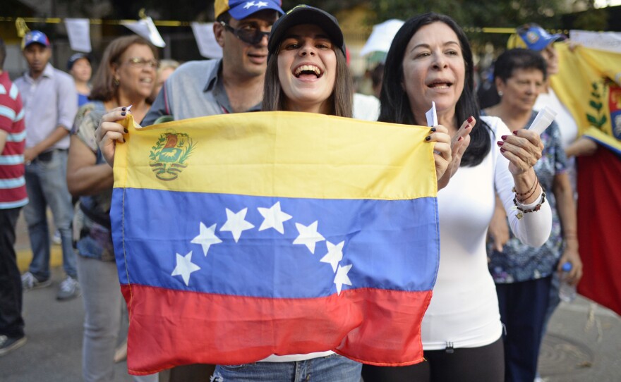 Activists celebrate Sunday in Caracas after voting in an opposition-organized referendum on President Nicolas Maduro's plan to rewrite the country's constitution.