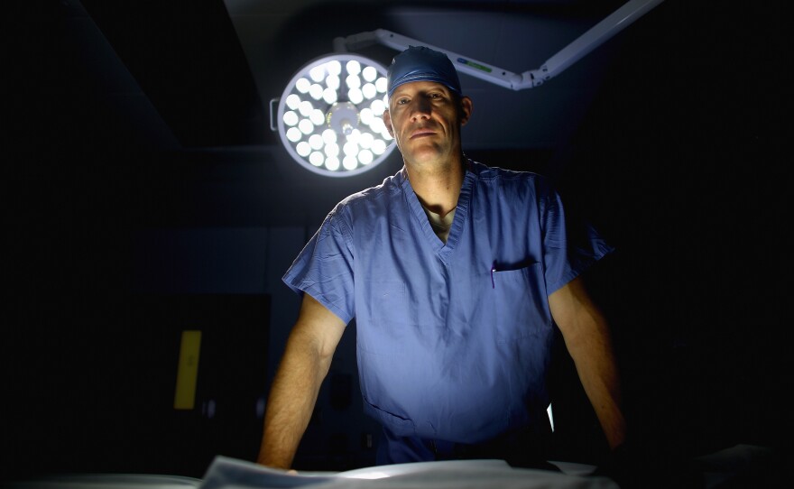 U.S. Air Force Lt. Col. Chance Henderson, an orthopedic surgeon, stands in the operating theater of the military hospital at Bagram Airfield in Afghanistan. Henderson has saved the leg of a 6-year-old Afghan girl who was shot during a firefight between U.S. and Afghan forces and the Taliban.