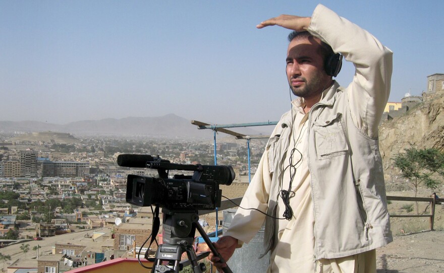 This July 2011 photograph shows Zabihullah Tamanna as he films a report on the outskirts of Kabul.