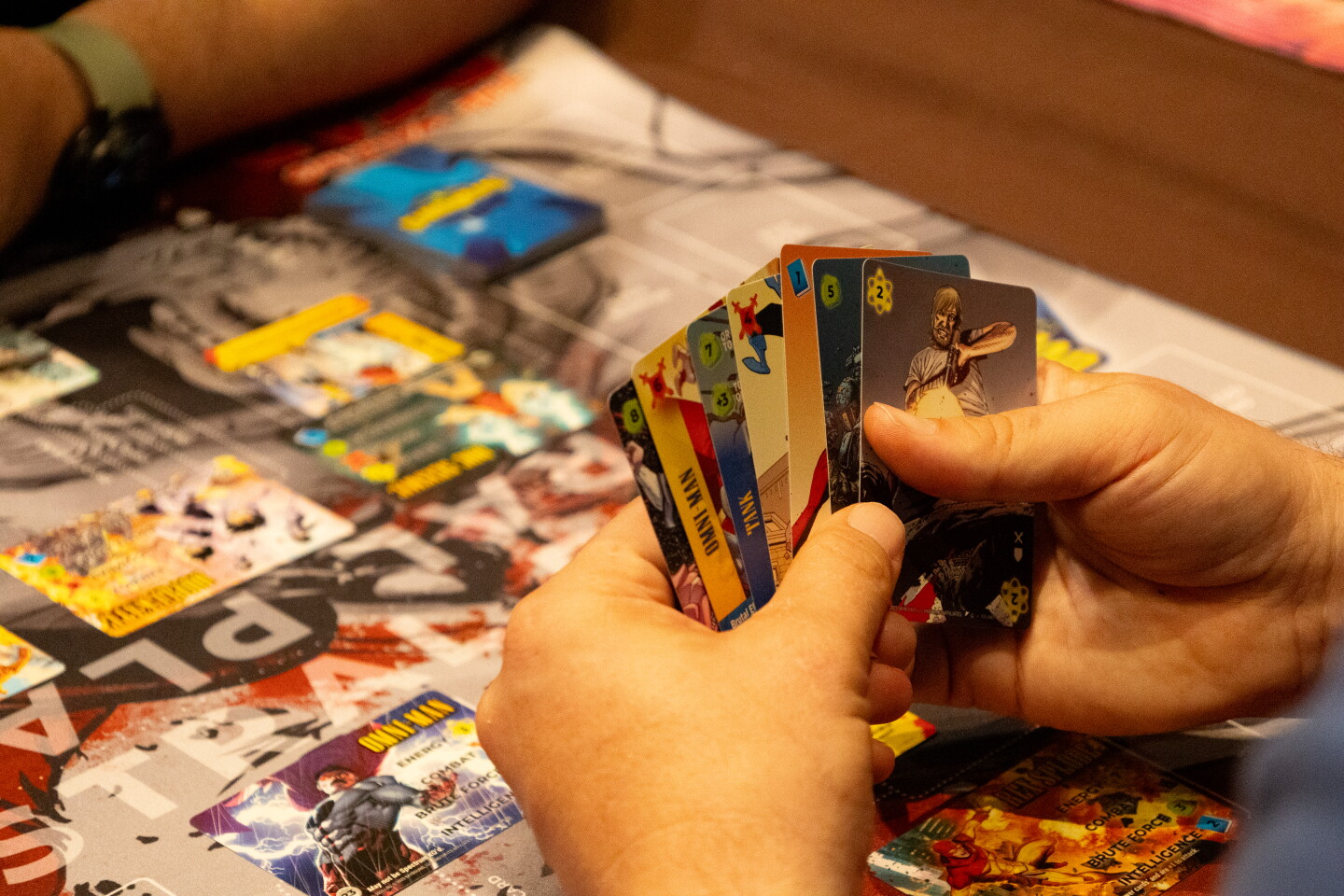 An attendee plays a card game in one of Comic-Con's gaming rooms, July 24, 2026.