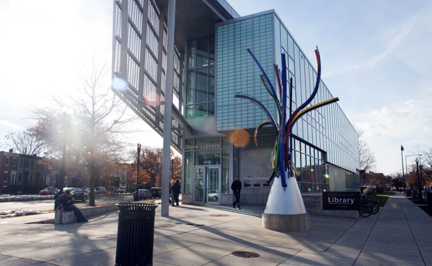 People walk in front of the Shaw Library. The redesigned library opened in 2010.