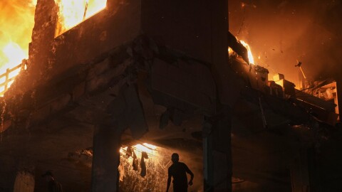 Palestinians react to a fire following an Israeli strike on a residential building in the Rimal neighborhood of Gaza City, Friday, May 15, 2026.