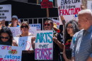 Protesters opposed to San Diego Mayor Todd Gloria's budget cuts to arts programs gather at San Diego's Civic Center Plaza before a City Council meeting on April 20, 2026.
