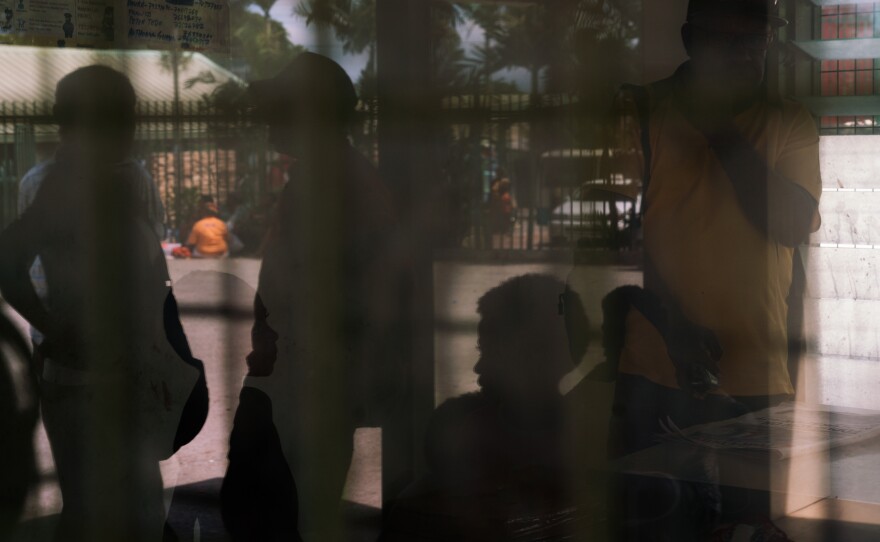 Residents of a settlement called Sabama wait outside a police station. Enforcement of domestic abuse laws can depend on where victims live, which local court takes the case and personal connections. Having local advocates can make a big difference.