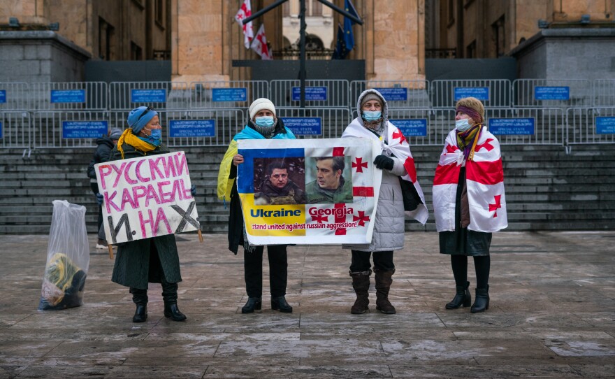 People stand in front of Parliament in Tbilisi, Georgia, to show their support for Ukraine.