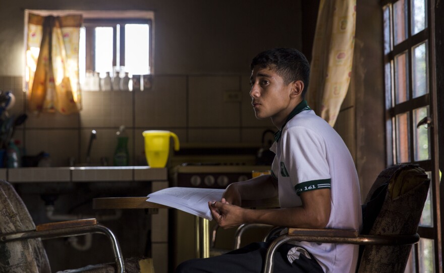 Jonathan Cosillos, 18, works on homework in his kitchen in Sonora, Mexico, on Aug. 28, 2015.
