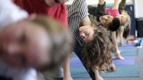 In this Dec. 11, 2012 file photo, students hold their position during a yoga class at Capri Elementary School in Encinitas, Calif.