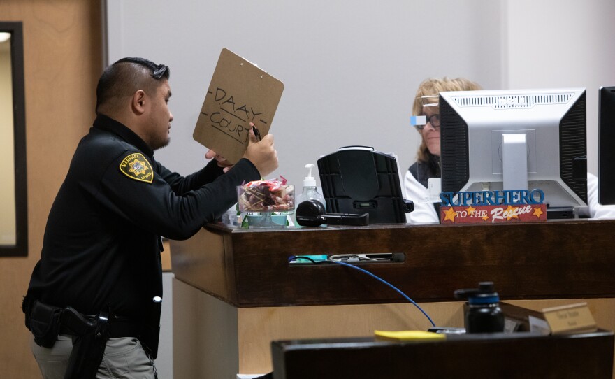 Judge Sunny Bailey's Marshal Oscar Arante and assistant Ruthie Denning talk during proceedings at DAAY court.